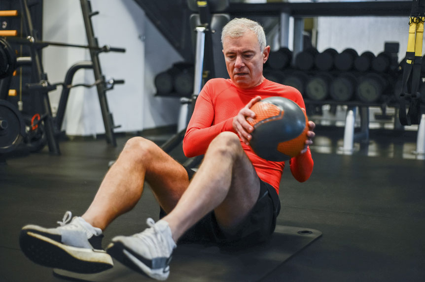 man working out with medicine ball