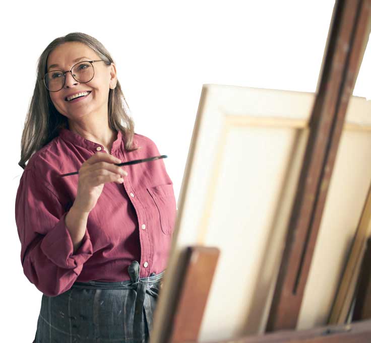 cheerful female pensioner in an apron and eyeglasses